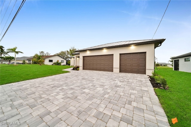 view of front of property with a garage and a front yard