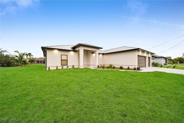 prairie-style home featuring a front lawn and a garage