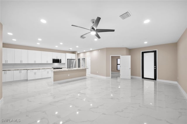 unfurnished living room with ceiling fan