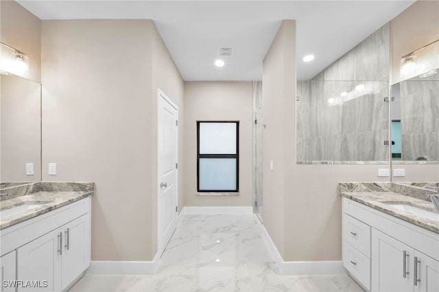 bathroom with tiled shower and vanity