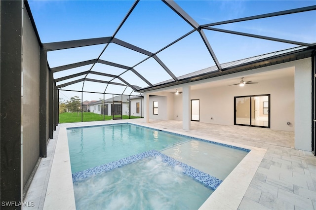 view of pool with a patio, ceiling fan, and glass enclosure