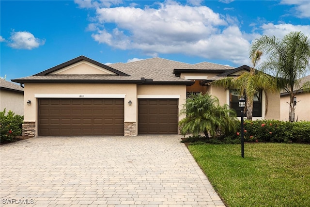 view of front of house featuring a garage and a front lawn