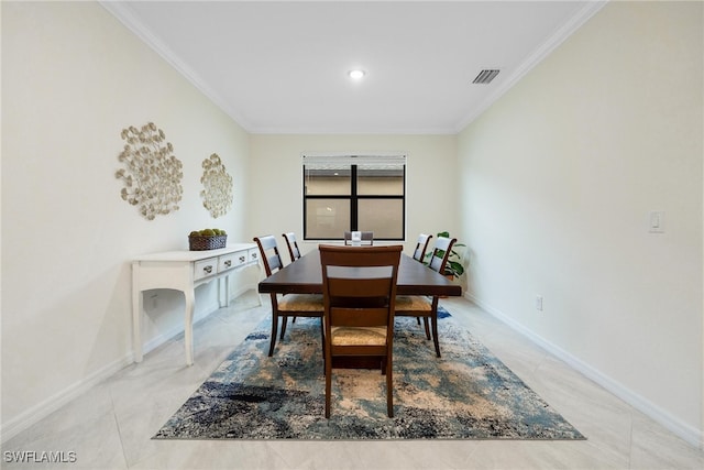 dining room featuring light tile patterned floors and ornamental molding