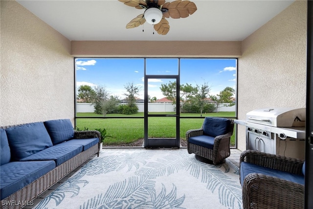 sunroom / solarium featuring a healthy amount of sunlight and ceiling fan