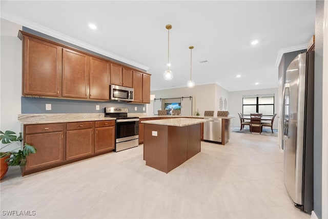 kitchen with crown molding, stainless steel appliances, a kitchen island, decorative light fixtures, and light stone countertops