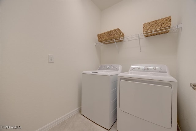 washroom featuring separate washer and dryer and light colored carpet