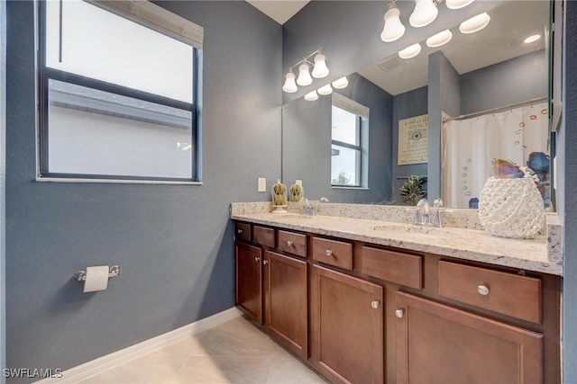 bathroom with a shower with curtain, vanity, and tile patterned floors