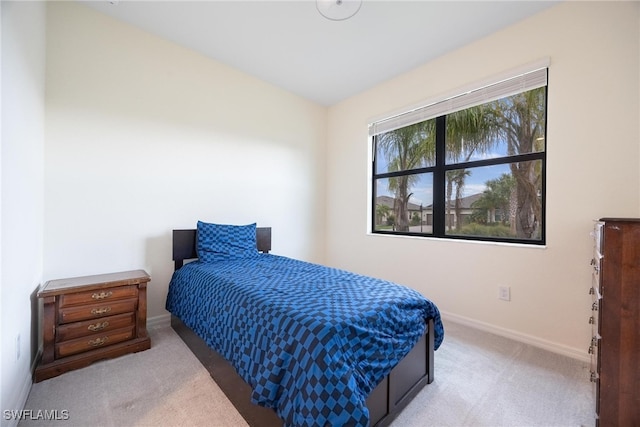 bedroom featuring light colored carpet