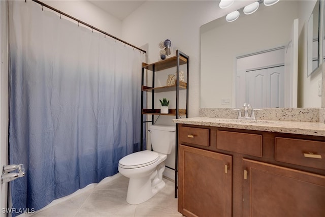 bathroom with vanity, tile patterned floors, and toilet