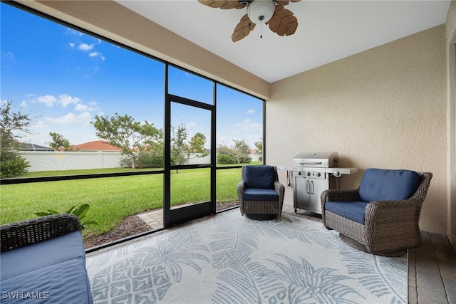 sunroom featuring ceiling fan