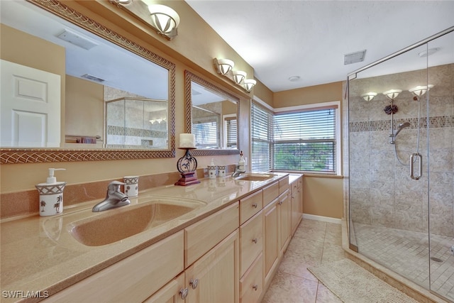 bathroom featuring tile patterned flooring, vanity, and walk in shower