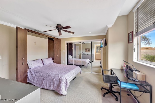 bedroom with light colored carpet, ceiling fan, and crown molding