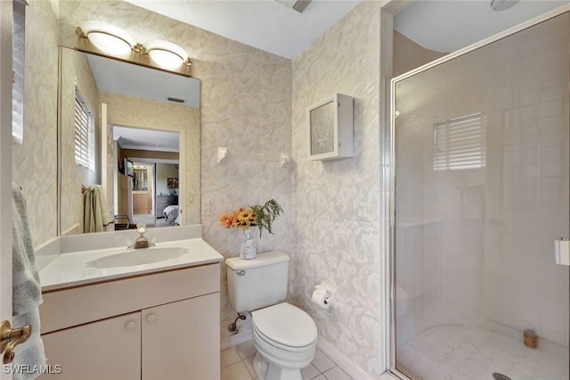 bathroom with tile patterned floors, toilet, an enclosed shower, and vanity