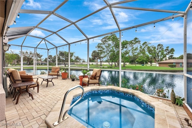 view of pool with a jacuzzi, a water view, glass enclosure, and a patio area