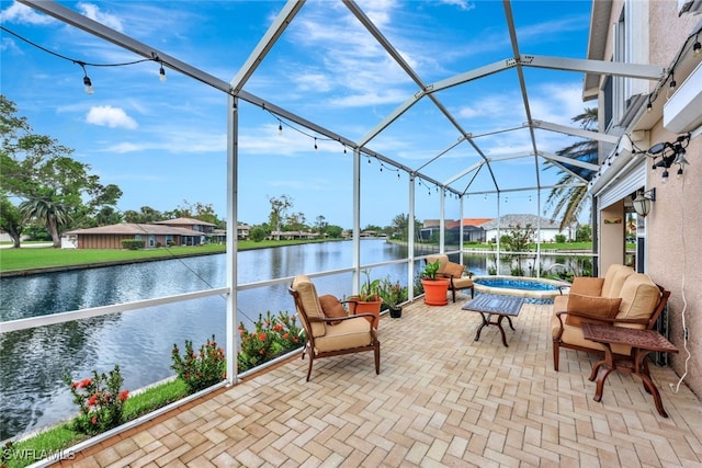 view of patio featuring a jacuzzi, a water view, and a lanai