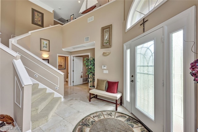 tiled foyer with a high ceiling