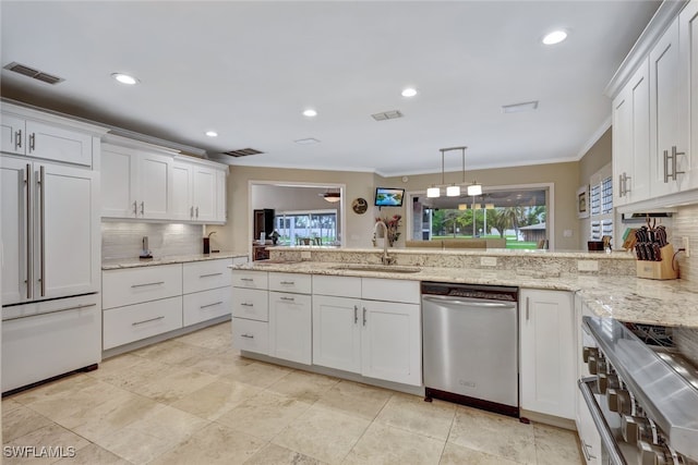 kitchen with white cabinets, high end appliances, and sink