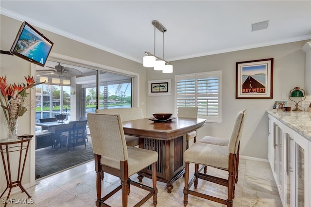 dining room featuring ceiling fan, light tile patterned floors, and crown molding