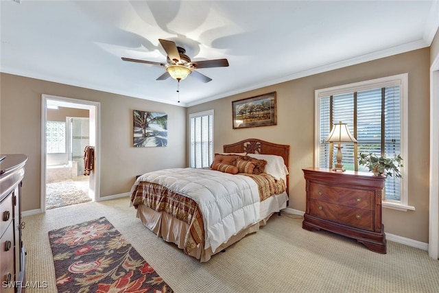 carpeted bedroom featuring ensuite bathroom, ceiling fan, and ornamental molding