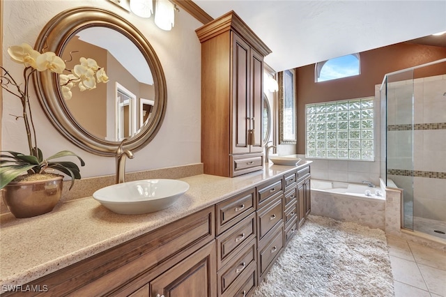 bathroom with tile patterned floors, vanity, and independent shower and bath