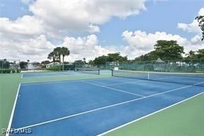 view of tennis court featuring basketball hoop