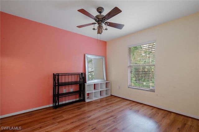 empty room with light hardwood / wood-style flooring and ceiling fan