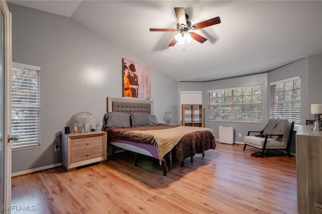 bedroom featuring vaulted ceiling, ceiling fan, and light hardwood / wood-style flooring