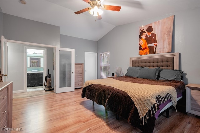 bedroom with connected bathroom, lofted ceiling, ceiling fan, and light hardwood / wood-style flooring