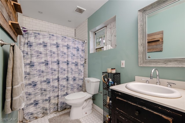 bathroom with curtained shower, tile patterned floors, vanity, and toilet