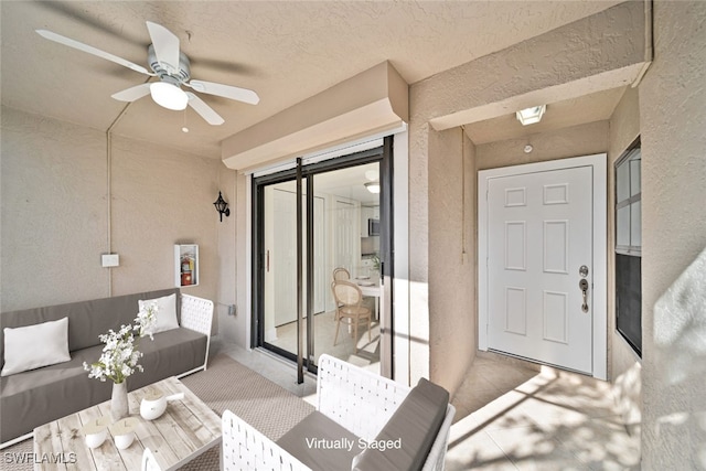 interior space with outdoor lounge area and ceiling fan