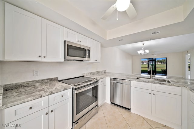 kitchen featuring ceiling fan with notable chandelier, sink, white cabinetry, and stainless steel appliances