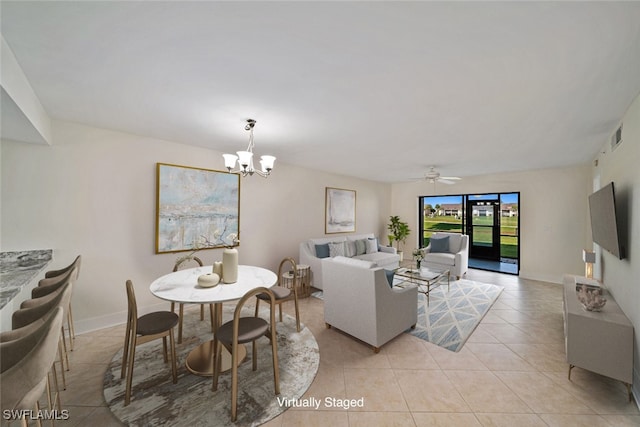 living room with light tile patterned floors and ceiling fan with notable chandelier