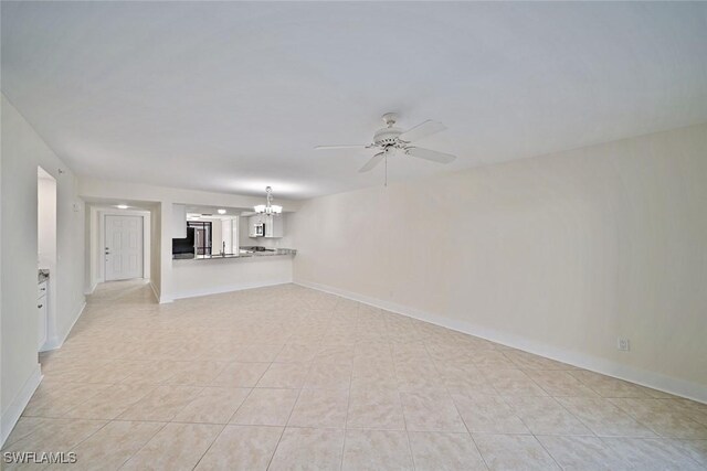 unfurnished living room featuring light tile patterned floors and ceiling fan with notable chandelier