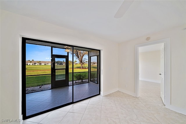 spare room featuring ceiling fan and light tile patterned floors