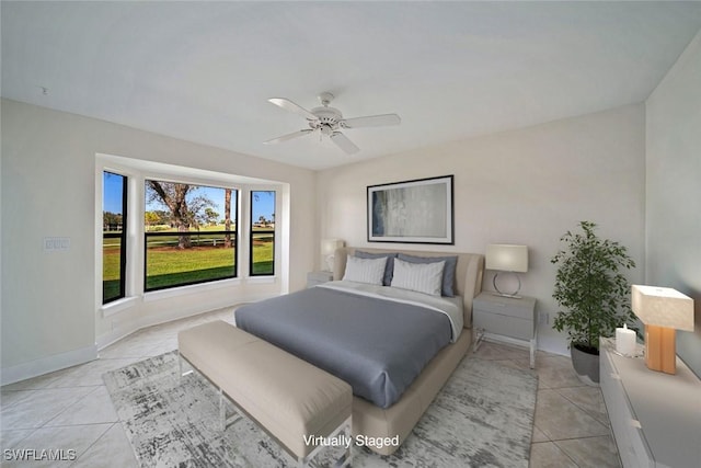 bedroom with ceiling fan and light tile patterned floors