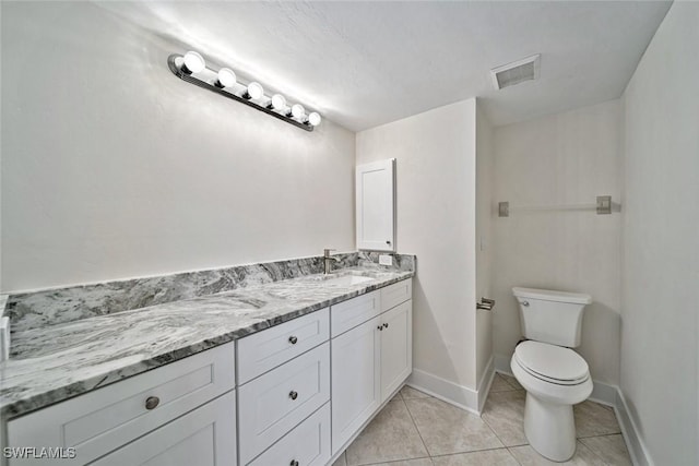 bathroom with tile patterned floors, vanity, and toilet