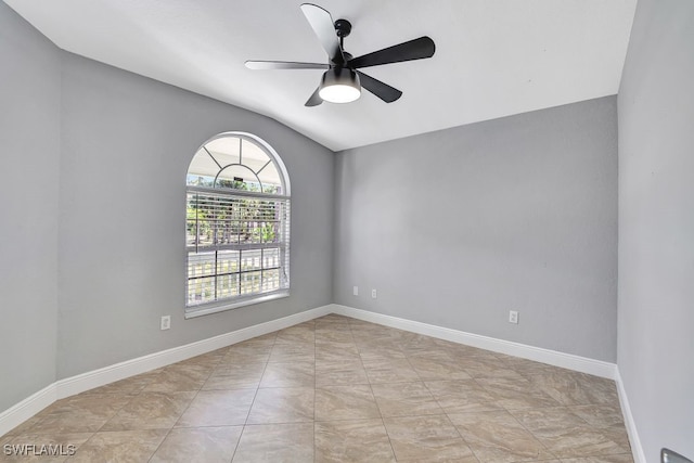 spare room featuring lofted ceiling and ceiling fan