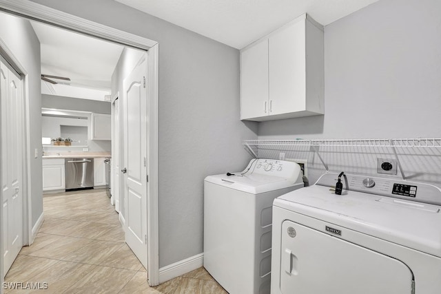 laundry room with cabinets and washer and clothes dryer