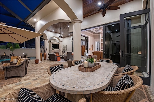 view of patio featuring an outdoor living space with a fireplace and ceiling fan