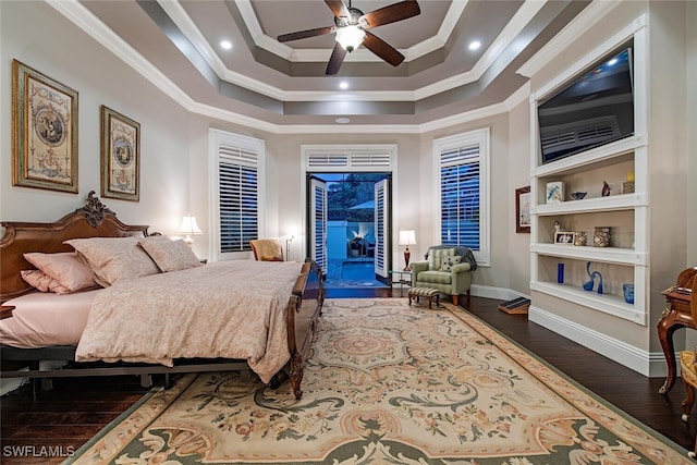 bedroom with a raised ceiling, ceiling fan, crown molding, and dark wood-type flooring