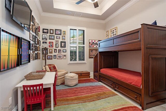 bedroom featuring ceiling fan, a raised ceiling, light wood-type flooring, and crown molding