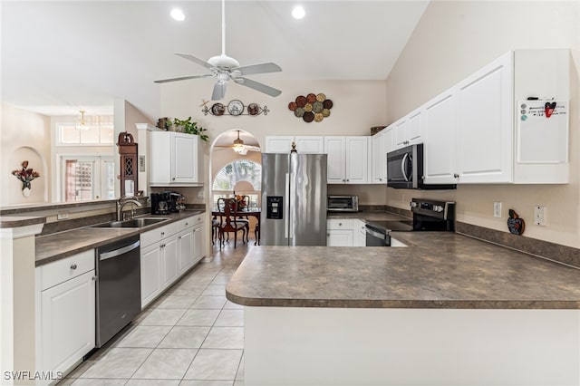 kitchen with kitchen peninsula, white cabinets, sink, and appliances with stainless steel finishes