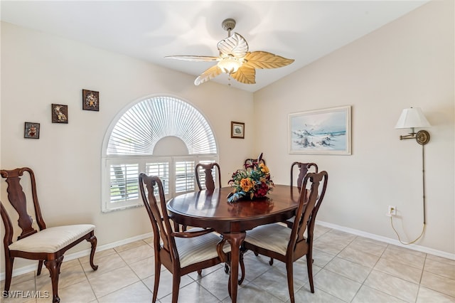 tiled dining room featuring lofted ceiling and ceiling fan