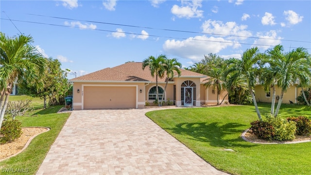 mediterranean / spanish house featuring a front lawn and a garage