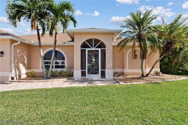 entrance to property featuring a yard