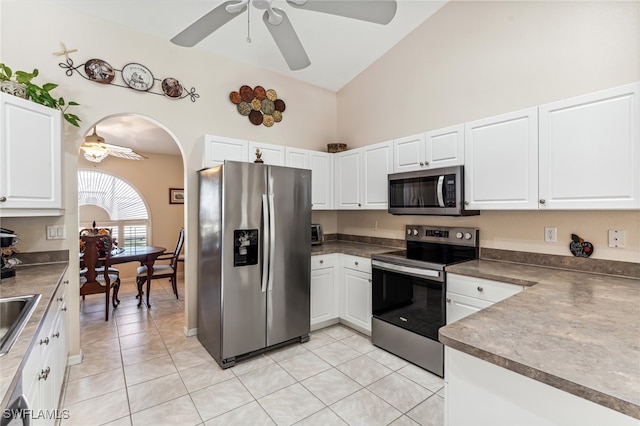 kitchen featuring white cabinets, light tile patterned floors, high vaulted ceiling, ceiling fan, and appliances with stainless steel finishes