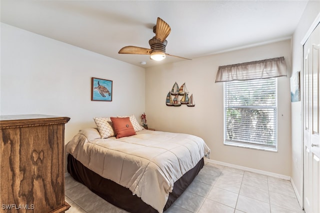 tiled bedroom featuring a closet and ceiling fan