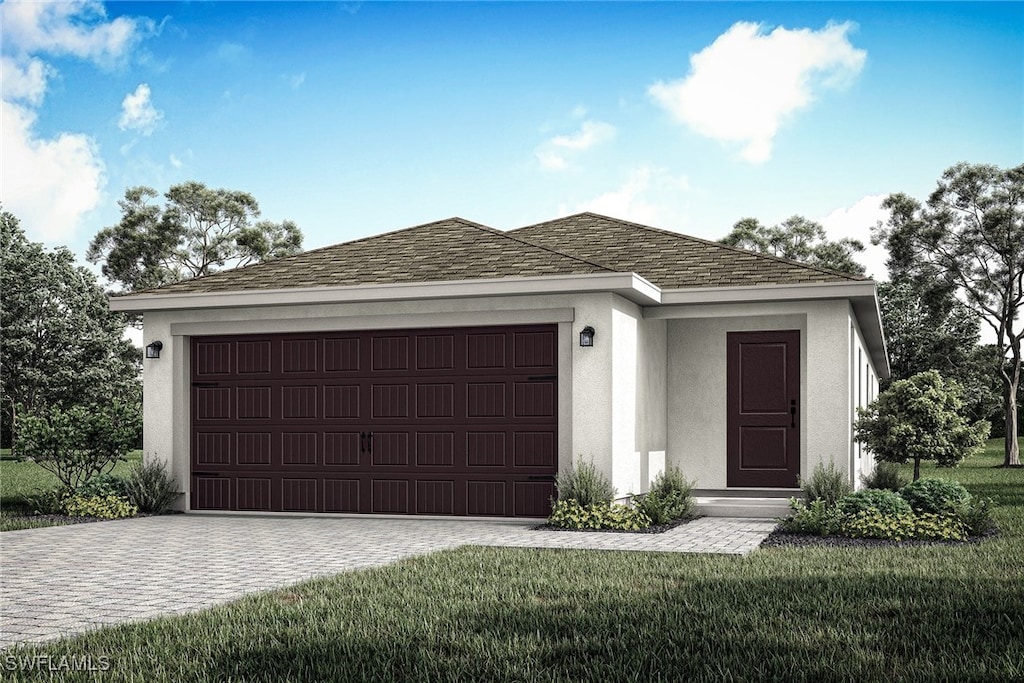 view of front of home with a front yard and a garage