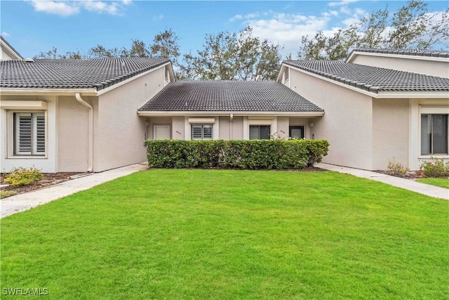 rear view of property featuring a yard