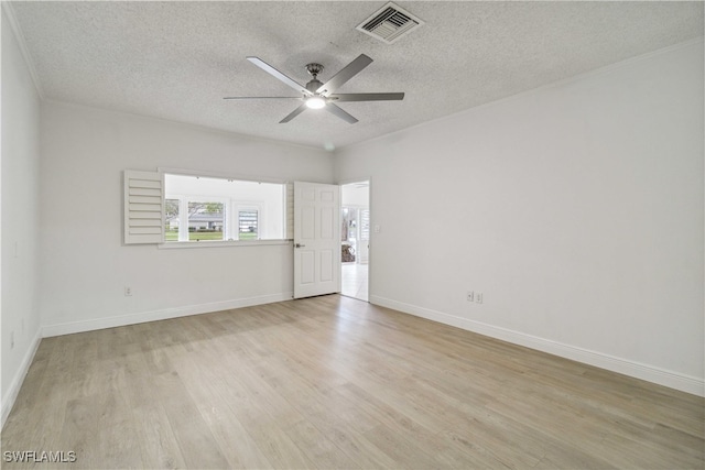 spare room with ceiling fan, light hardwood / wood-style floors, and a textured ceiling